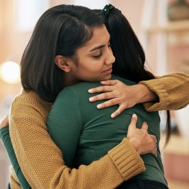 Cropped shot of two young women embracing each other